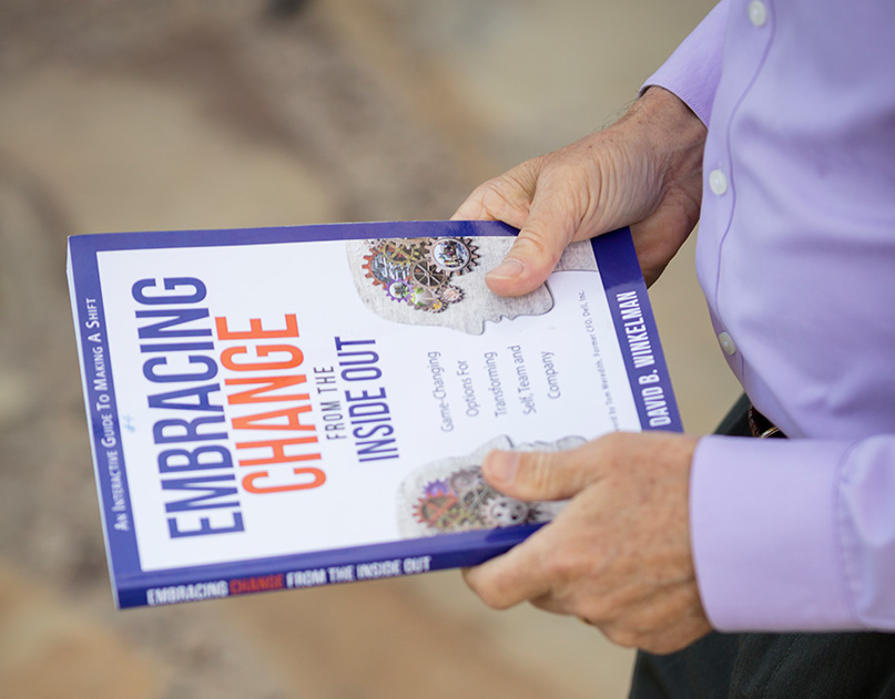 A person holding an embracing change book